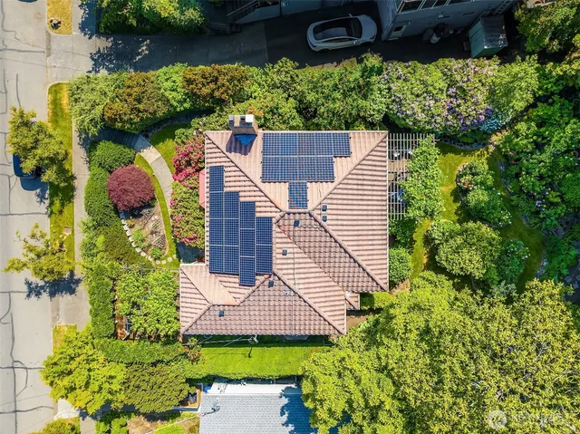 an aerial view of a house with a yard and potted plants