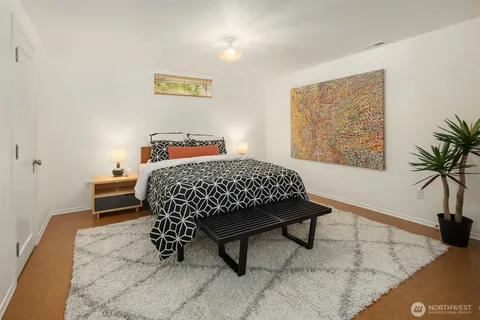 a bedroom with a bed and a potted plant