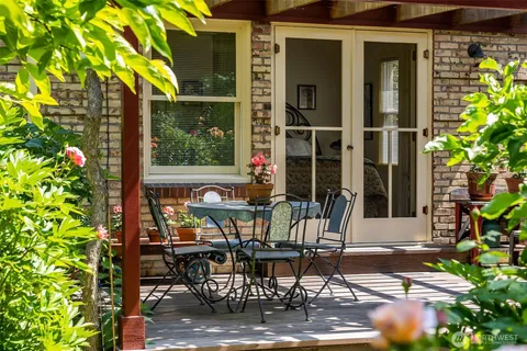 a view of a patio with table and chairs and potted plants