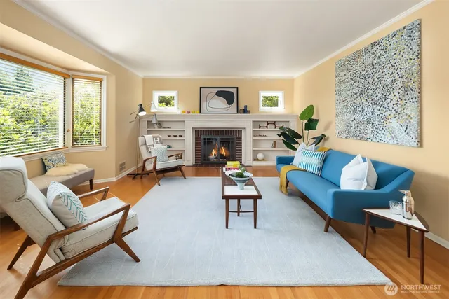 a living room with furniture a fireplace and a large window