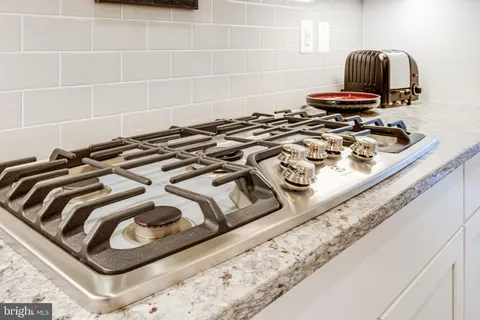 a living room with furniture a flat screen tv and a floor to ceiling window
