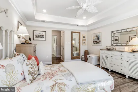 a bedroom with a bed and a refrigerator