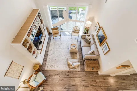 a dining room with furniture and potted plants