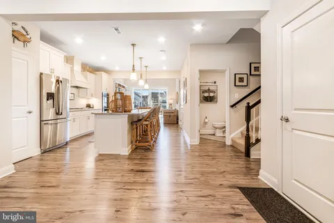 a kitchen with granite countertop a sink a counter top space appliances and cabinets