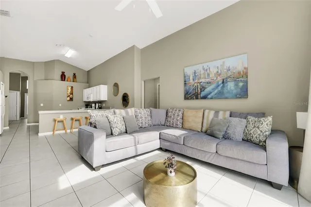 a living room with furniture and a painting