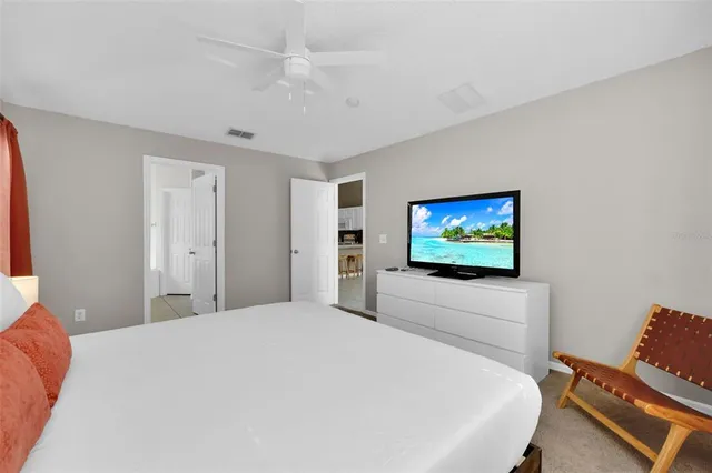 a bedroom with a bed and a flat screen tv