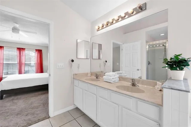 a bathroom with a tub sink and mirror