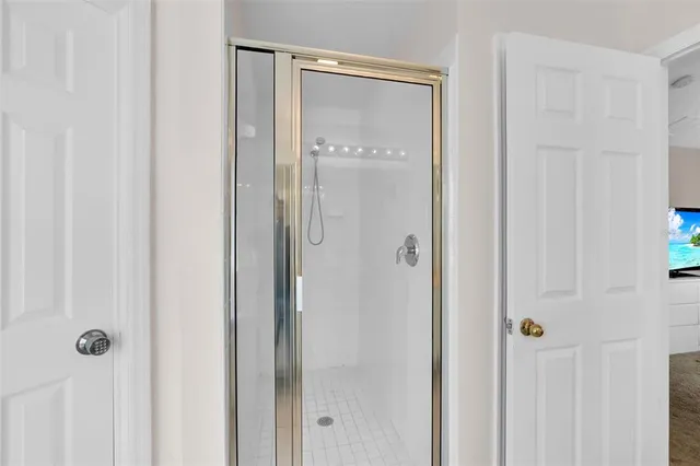 a bathroom with a glass shower door
