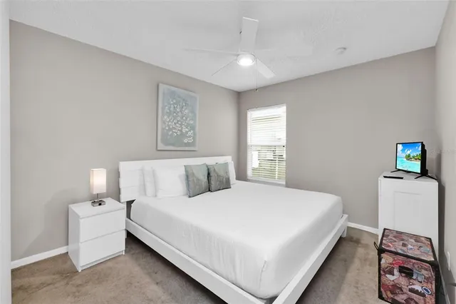 a bedroom with a large bed and a window