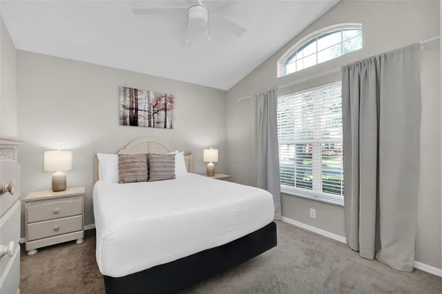 a bedroom with a large bed and a night stand