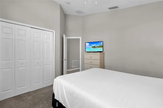 a bedroom with a bed and a painting on the wall