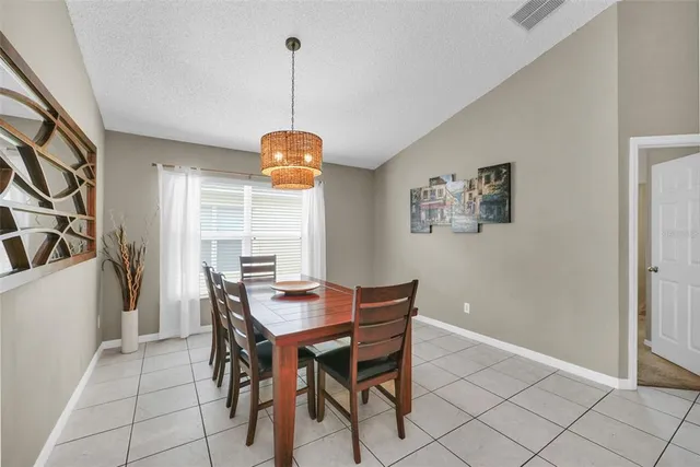 a view of a dining room with furniture and window