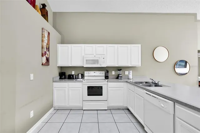 a kitchen with a sink a stove and cabinets