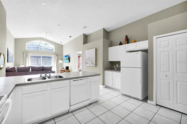 a kitchen with white cabinets and white appliances