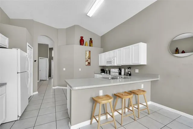 a kitchen with stainless steel appliances granite countertop a sink and a refrigerator