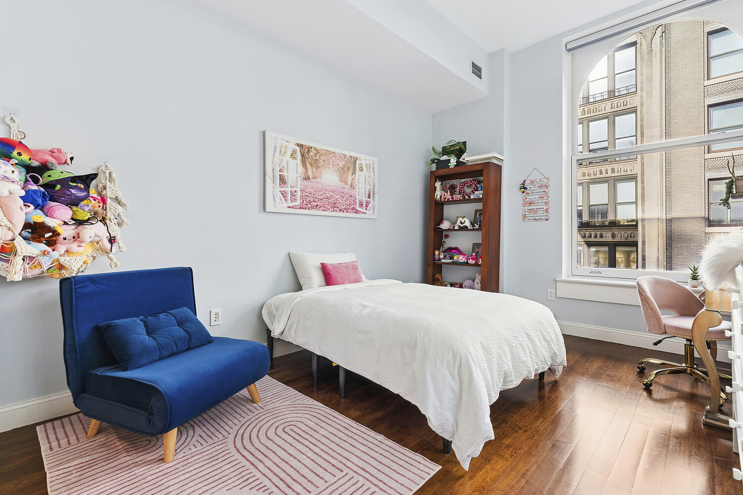42 East 20th Street, Unit 7A Manhattan, NY 10003 - Photo 10 of 13 a bedroom with a bed a dresser and a book shelf