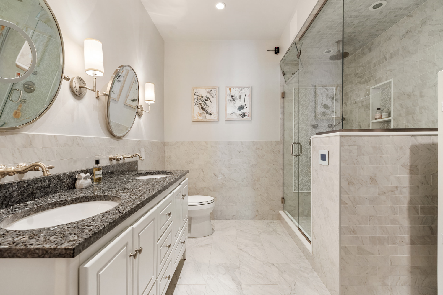 42 East 20th Street, Unit 7A Manhattan, NY 10003 - Photo 9 of 13 a bathroom with a granite countertop sink a mirror a toilet and a shower