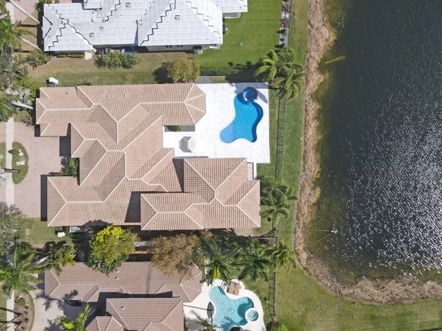 an aerial view of a house with a yard