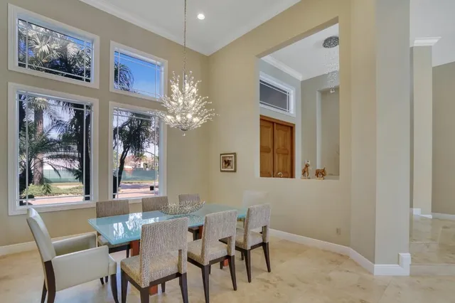 a view of a dining room with furniture and chandelier