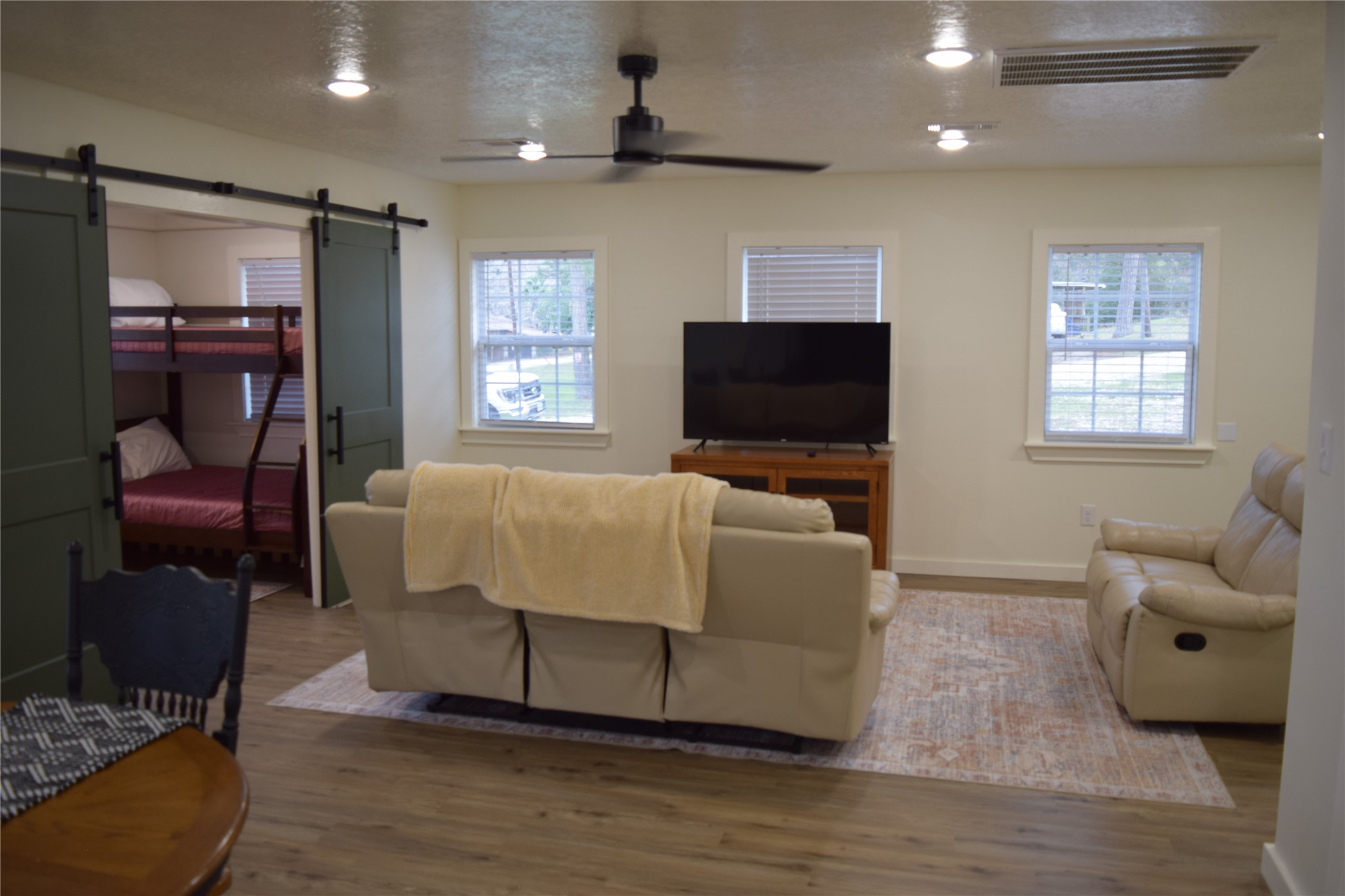 237 Shawnee Drive Onalaska, TX 77360 - Photo 11 of 32 a living room with furniture and a flat screen tv