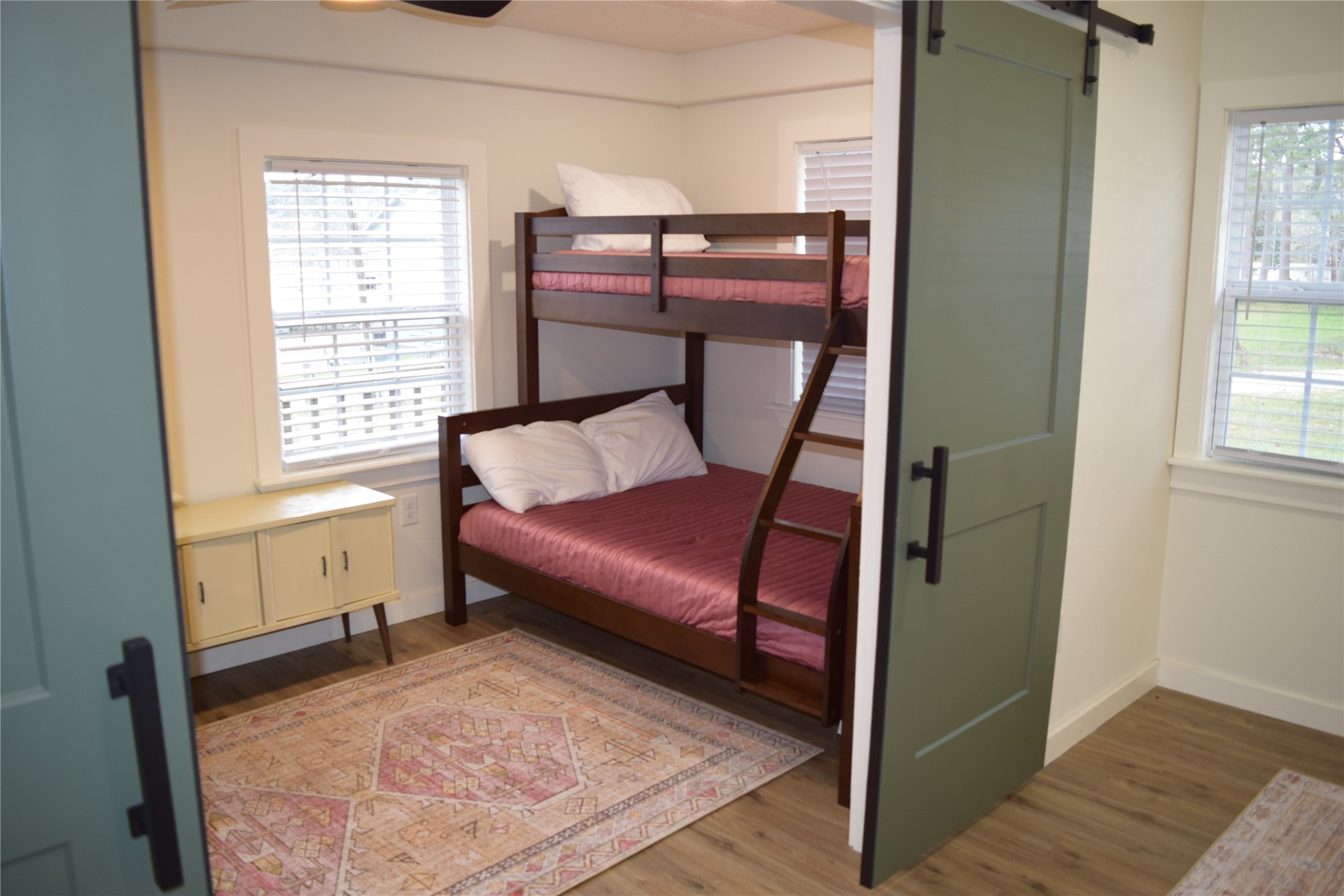 237 Shawnee Drive Onalaska, TX 77360 - Photo 15 of 32 a bedroom with a bed and wooden floor