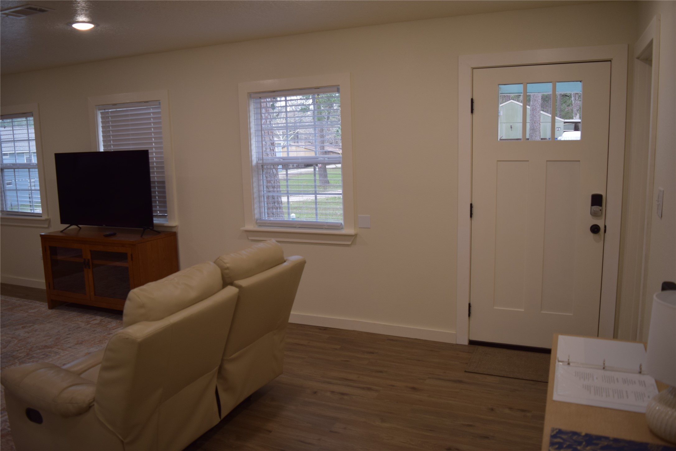237 Shawnee Drive Onalaska, TX 77360 - Photo 16 of 32 a living room with furniture and a flat screen tv