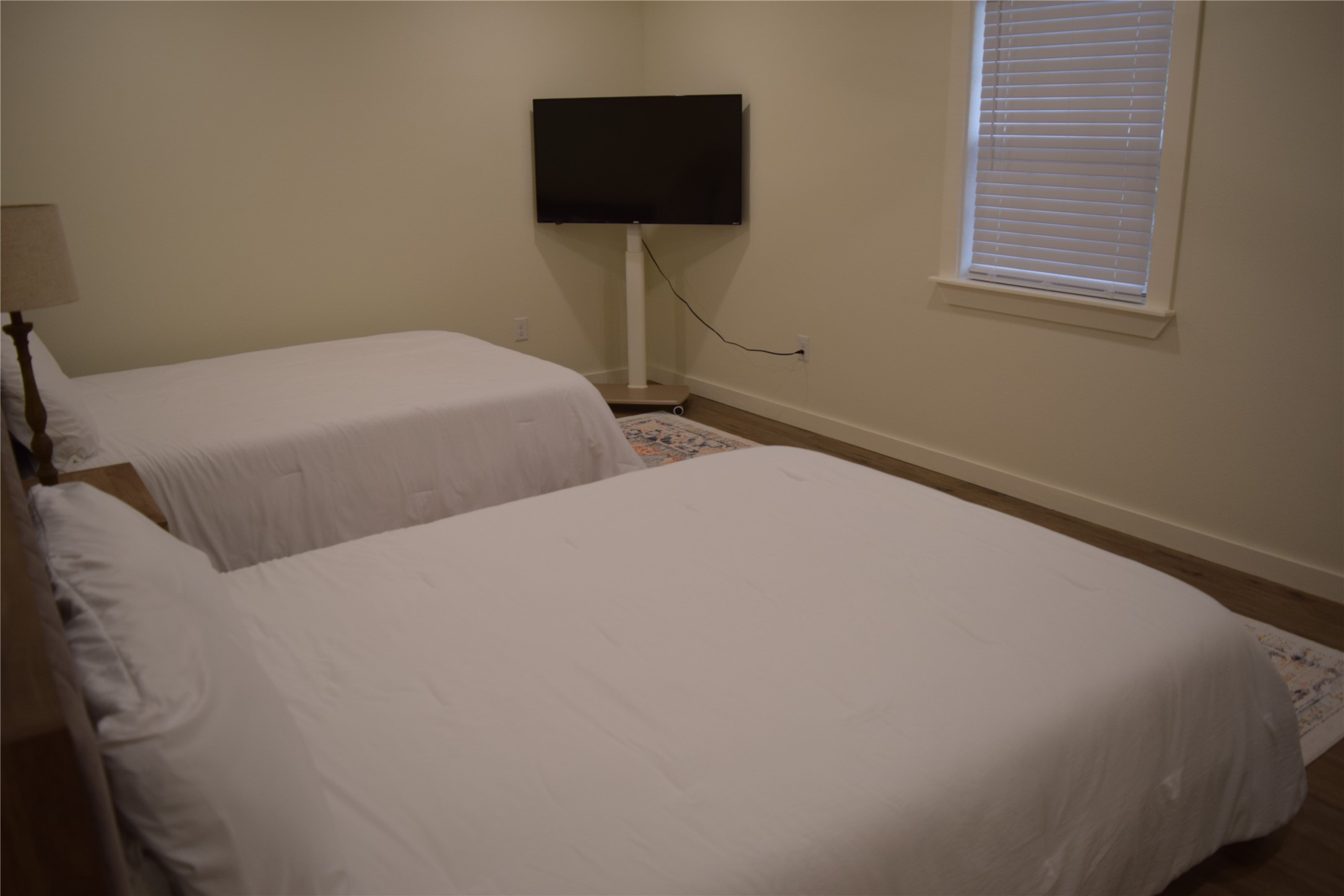 237 Shawnee Drive Onalaska, TX 77360 - Photo 18 of 32 a bedroom with two bed and a flat screen tv