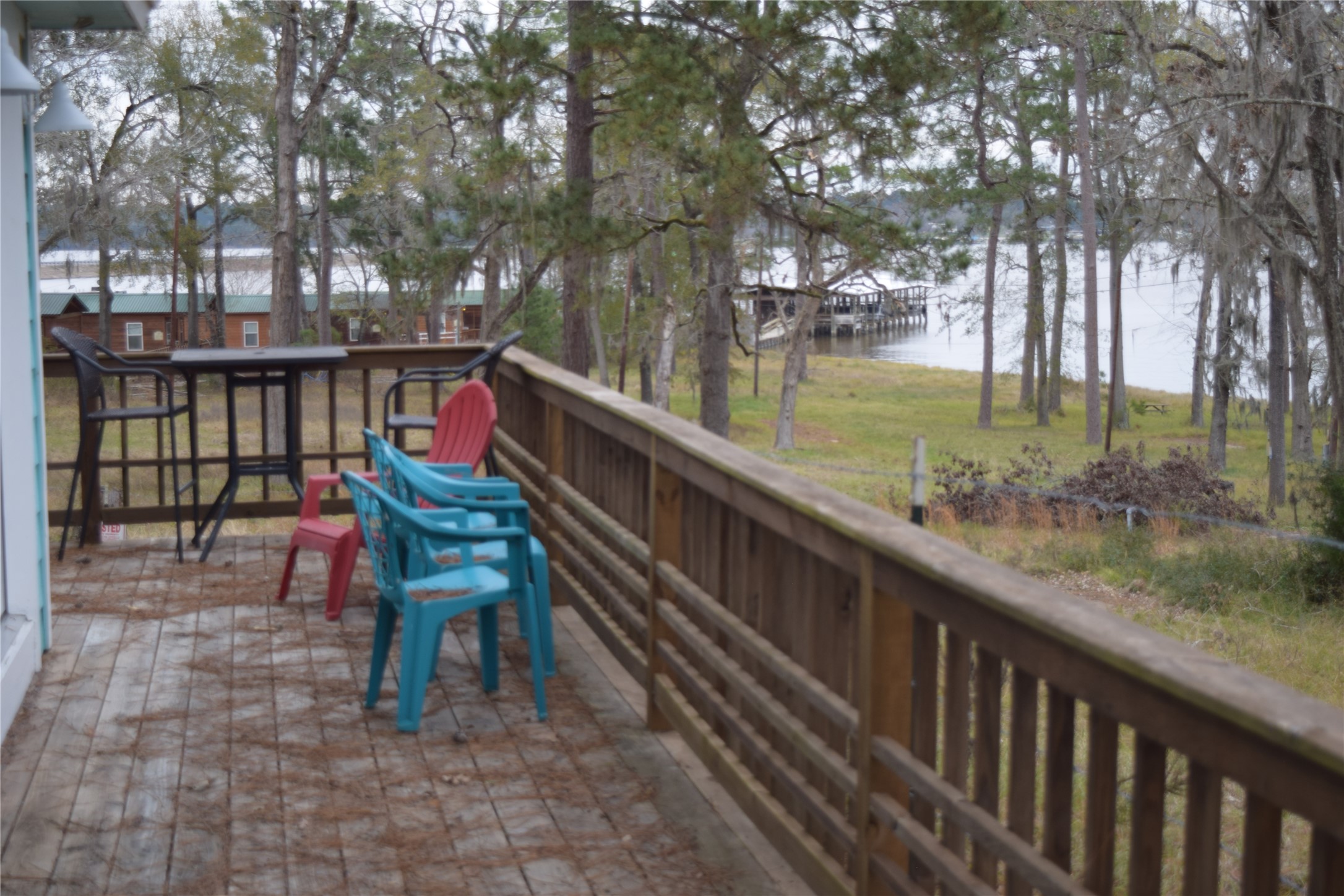 237 Shawnee Drive Onalaska, TX 77360 - Photo 25 of 32 a balcony with wooden floor and outdoor seating