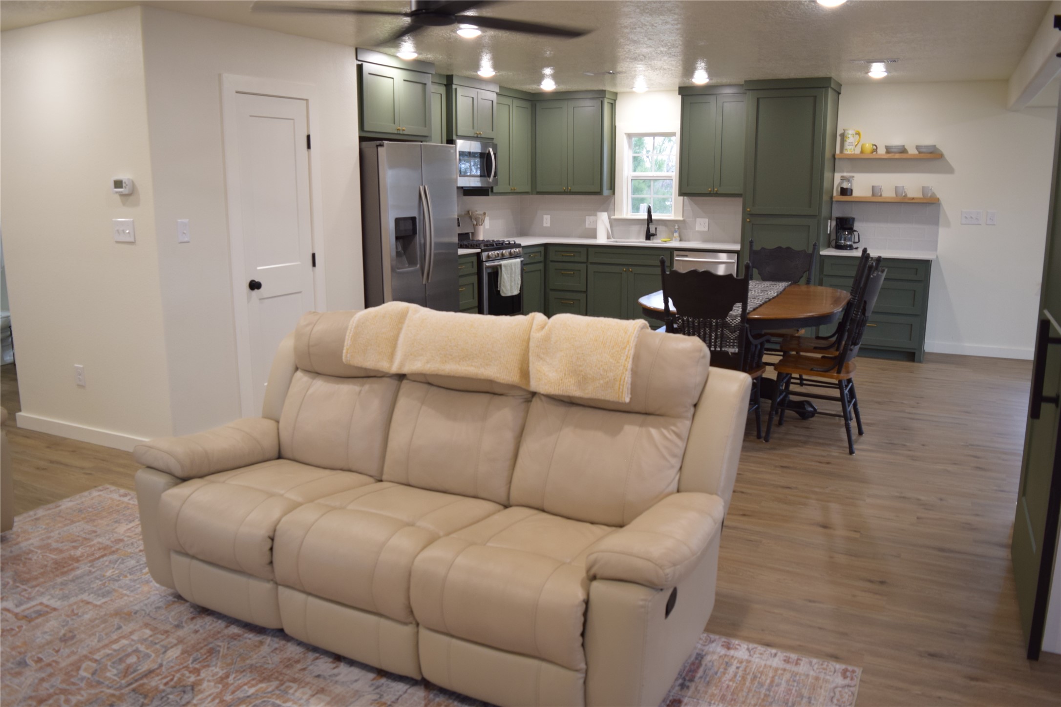 237 Shawnee Drive Onalaska, TX 77360 - Photo 9 of 32 a living room with furniture and a dining table with kitchen view