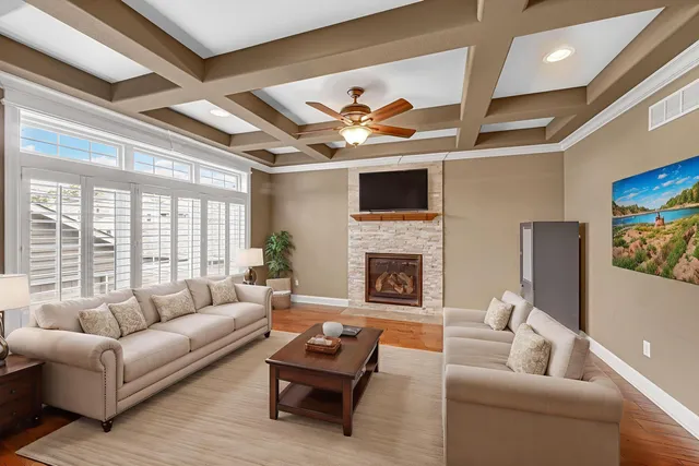 a living room with furniture a flat screen tv and a fireplace