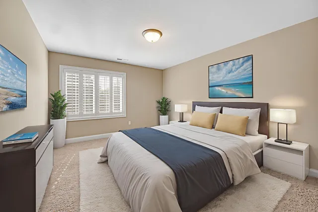 a spacious bedroom with a large bed and a window