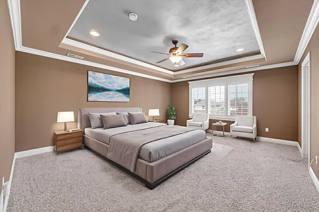 a spacious bedroom with a bed and a large window