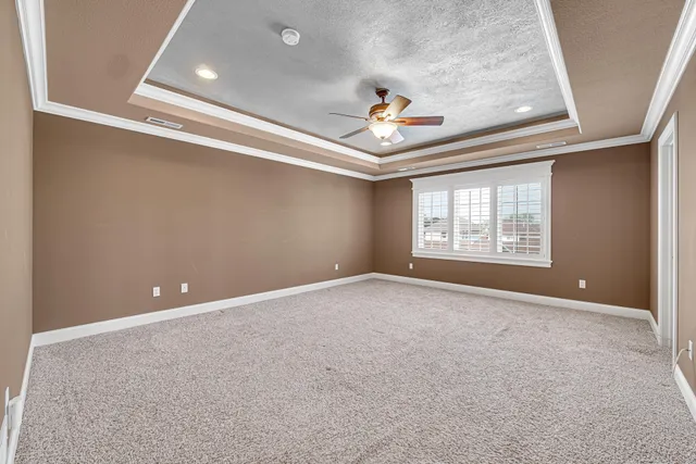 an empty room with windows and flowerpot