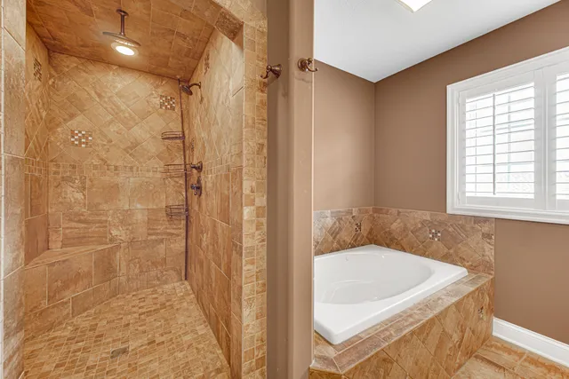 a bathroom with a tub and shower