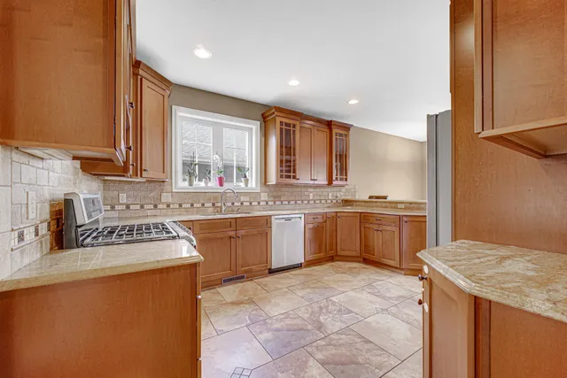a kitchen with a sink a counter top space and cabinets