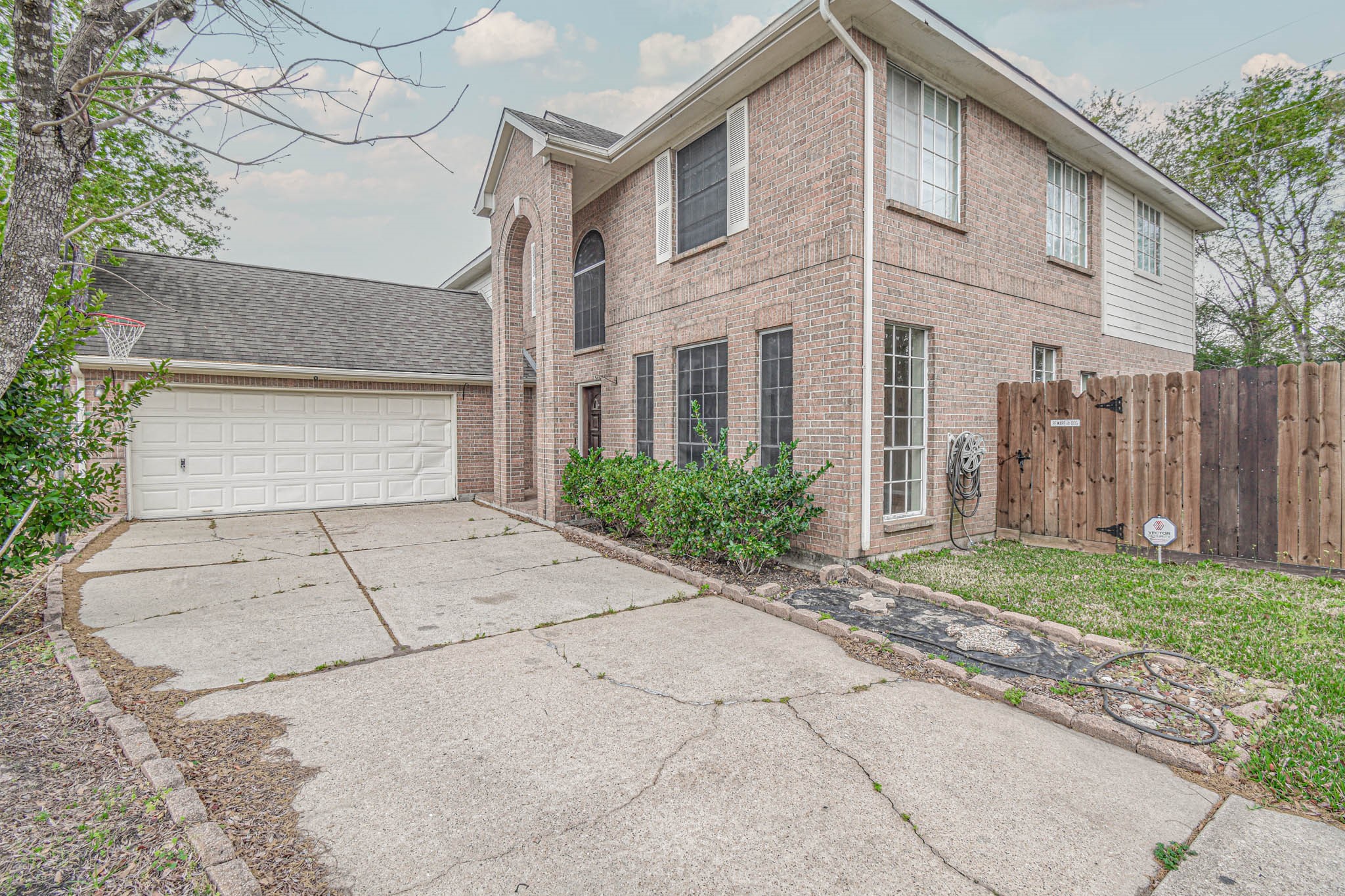 8806 Edenbridge Street Spring, TX 77379 - Photo 1 of 25 a view of a brick house with a yard and large tree