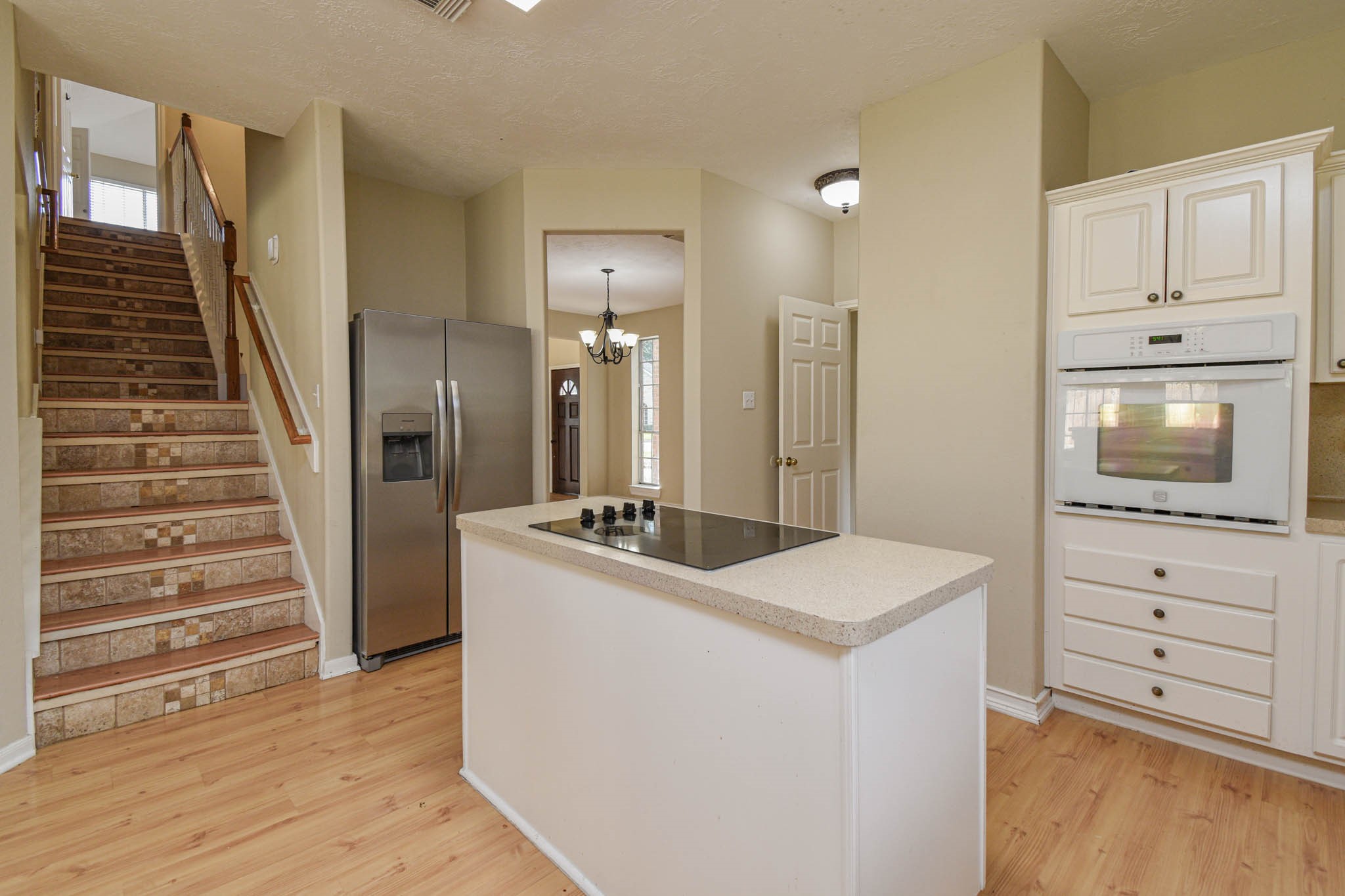 8806 Edenbridge Street Spring, TX 77379 - Photo 14 of 25 a view of kitchen with cabinets and wooden floor
