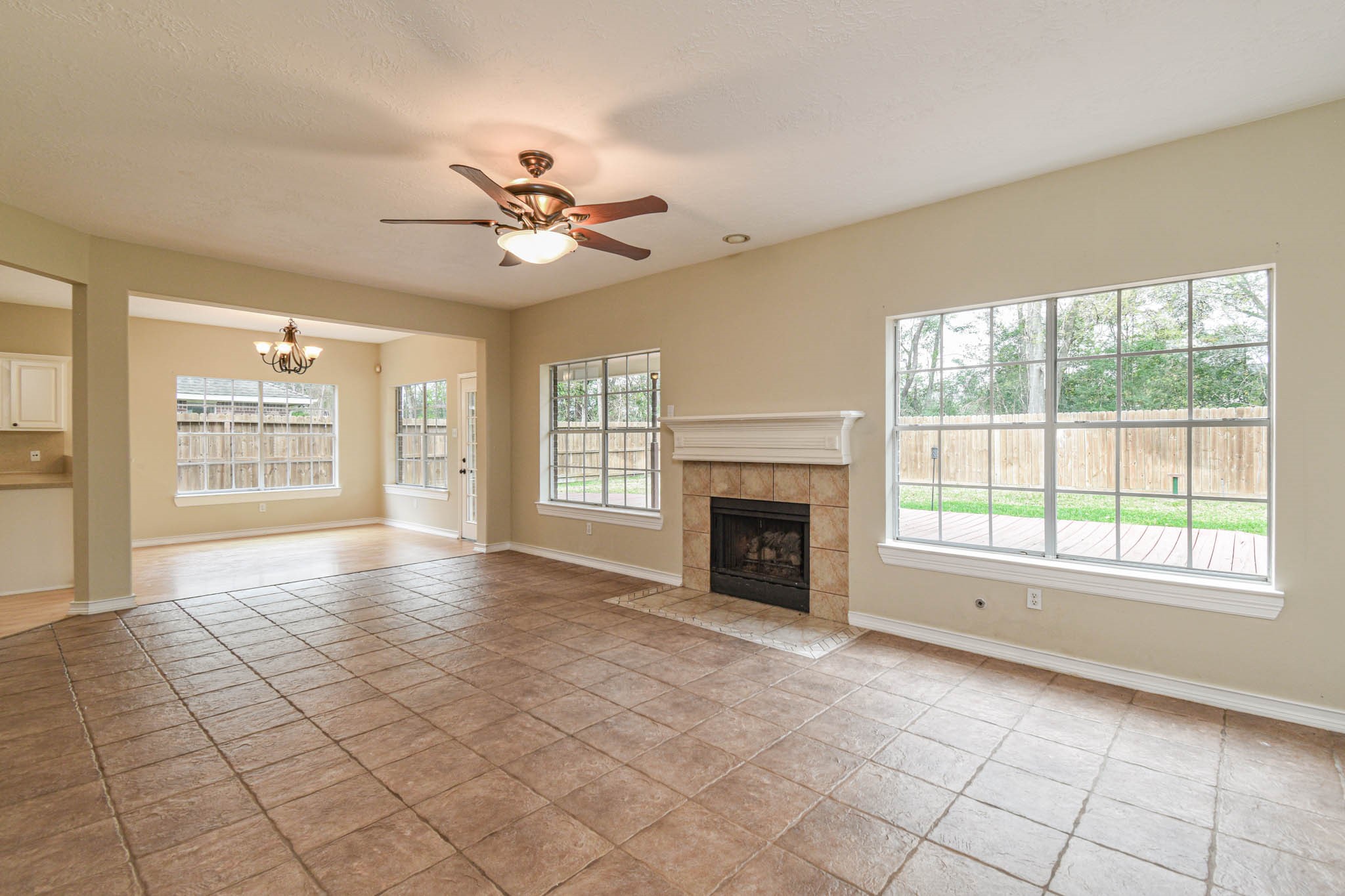 8806 Edenbridge Street Spring, TX 77379 - Photo 16 of 25 a view of an empty room with a fireplace and a window