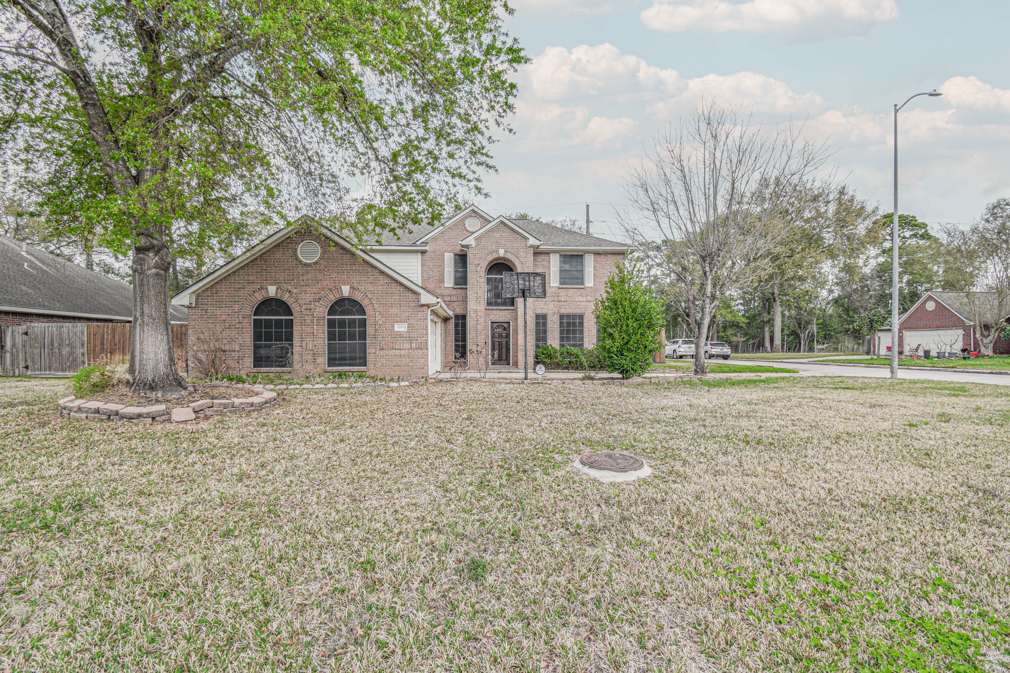 8806 Edenbridge Street Spring, TX 77379 - Photo 2 of 25 a view of a white house with a yard and large tree