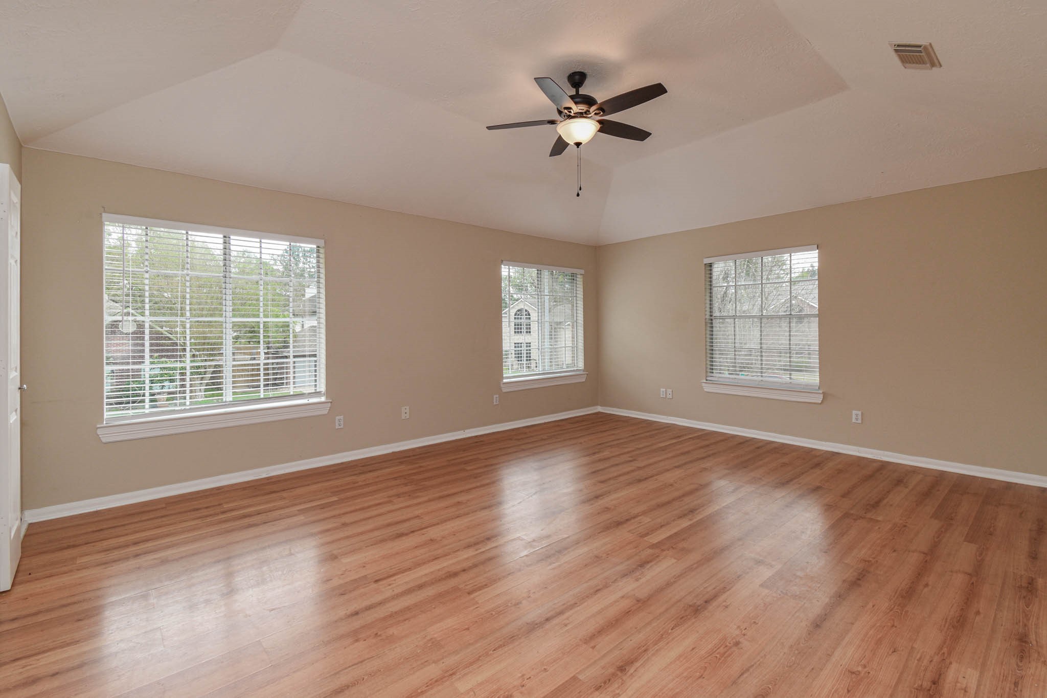 8806 Edenbridge Street Spring, TX 77379 - Photo 21 of 25 a view of an empty room with a window and wooden floor