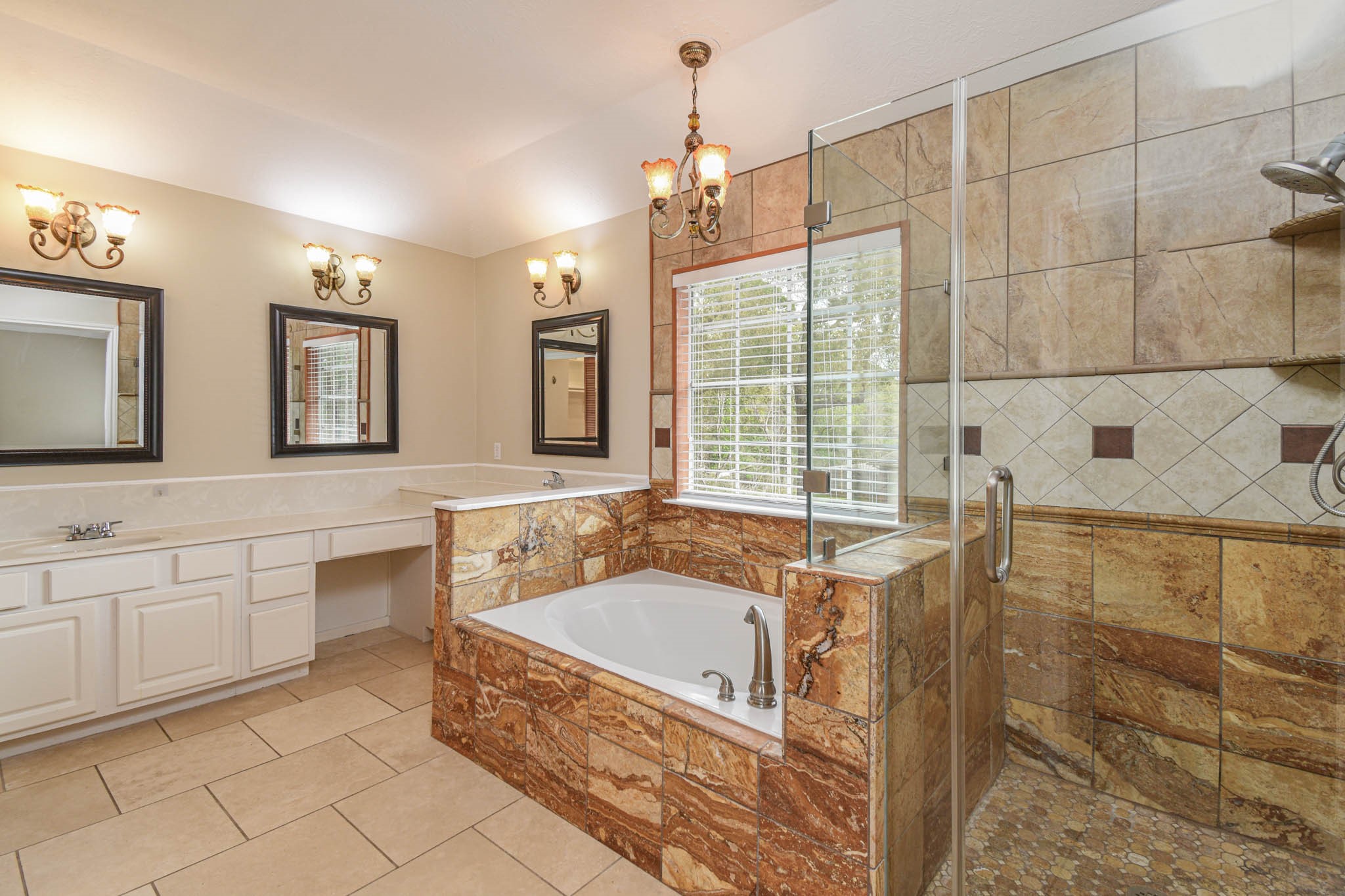 8806 Edenbridge Street Spring, TX 77379 - Photo 22 of 25 a spacious bathroom with a tub sink and mirror