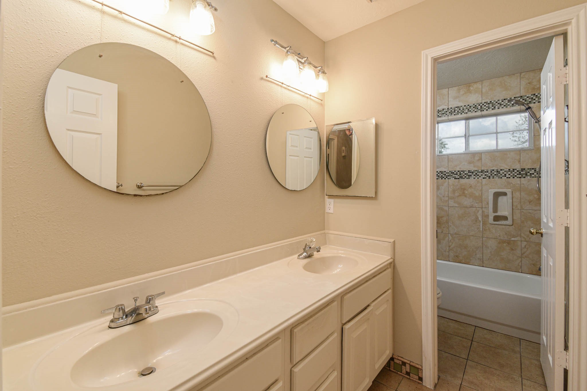 8806 Edenbridge Street Spring, TX 77379 - Photo 24 of 25 a bathroom with a sink and a mirror