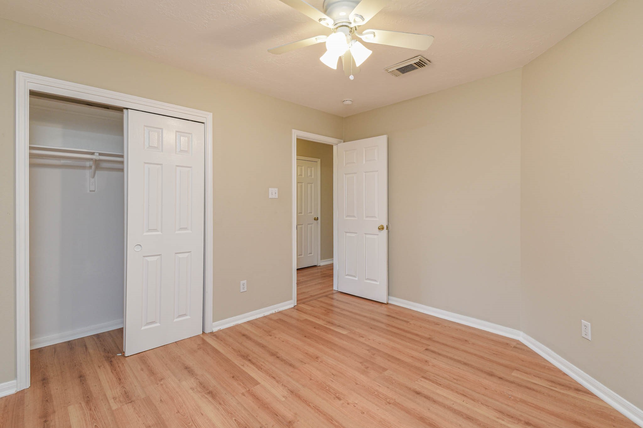 8806 Edenbridge Street Spring, TX 77379 - Photo 4 of 25 a view of an empty room with wooden floor