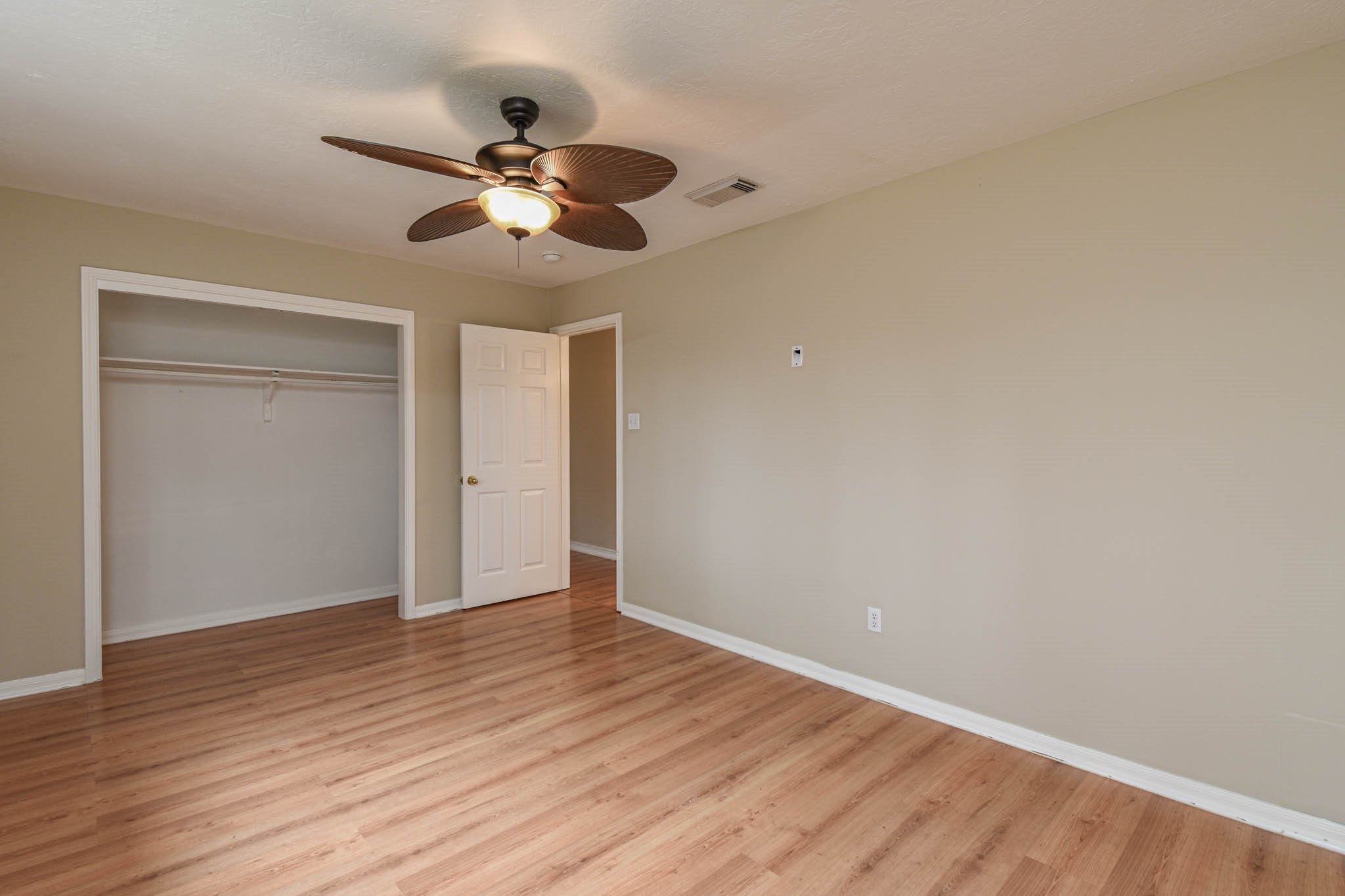 8806 Edenbridge Street Spring, TX 77379 - Photo 8 of 25 a view of an empty room with wooden floor