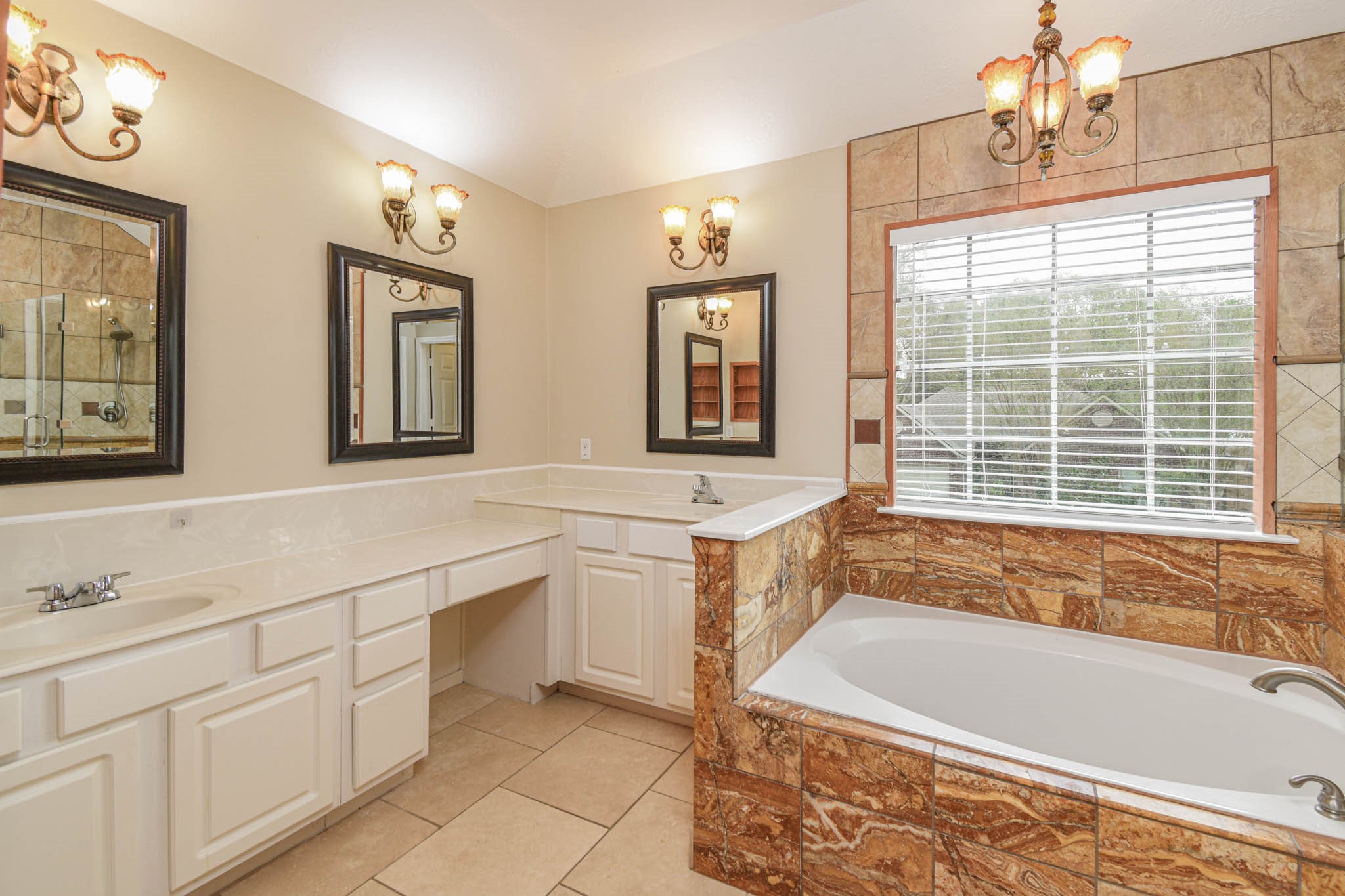 8806 Edenbridge Street Spring, TX 77379 - Photo 10 of 25 a spacious bathroom with a granite countertop tub sink and mirror