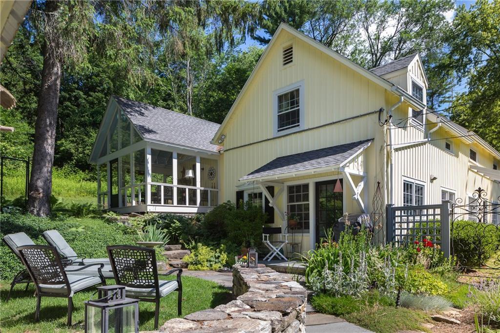 a view of a house with backyard sitting area and garden
