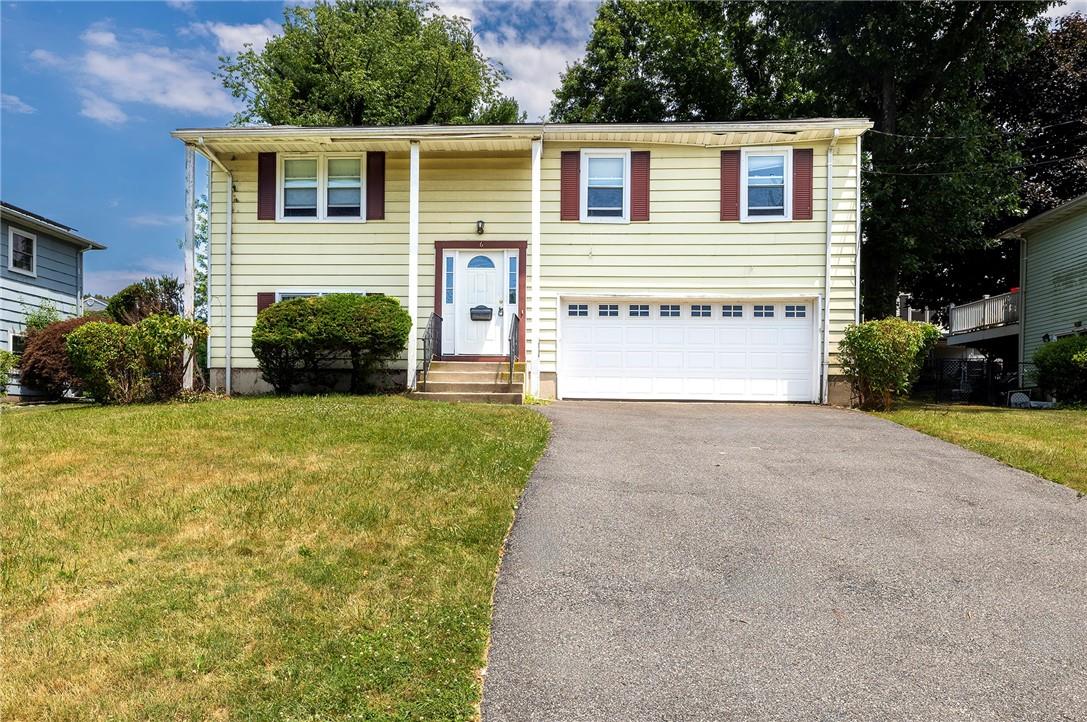 Raised ranch with a garage and a front yard