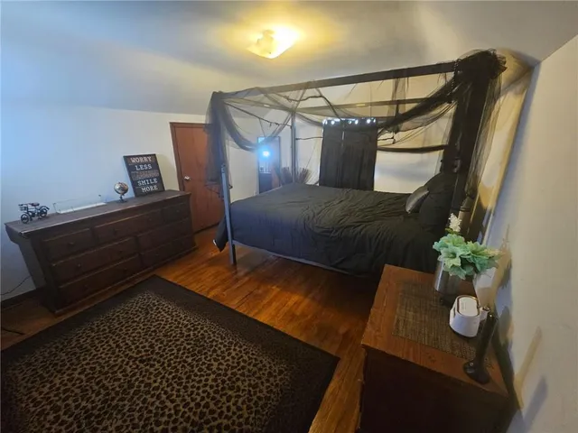 a bedroom with a bed and a potted plant