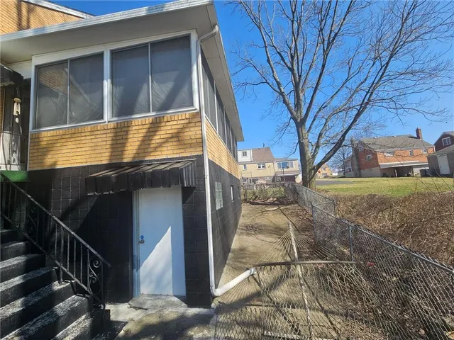 a front view of a house with a yard and lake view