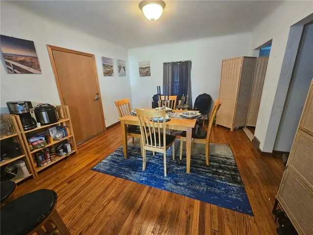 a dining room with furniture and wooden floor